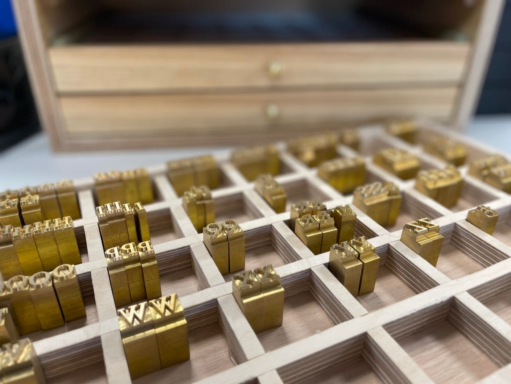 Brass initials used to personalise Moonreed leather goods